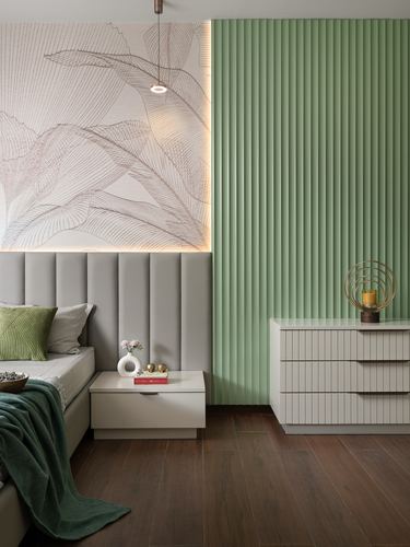 Bedroom with fluted sage green wall panel, tufted headboard, and dark wood flooring