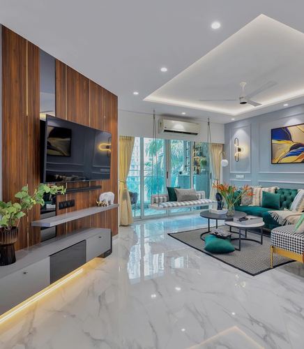 Living room with wood-panelled TV wall, marble floor, teal tufted sofa, and hanging swings by balcony