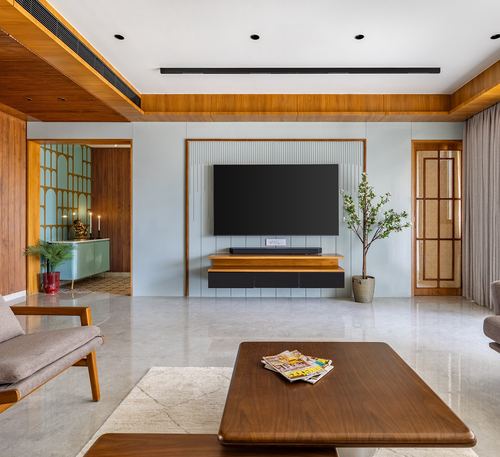 Pastel living room with wood-framed TV wall, floating console, marble floor, and coffee table