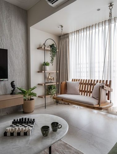 Living room corner with hanging wooden swing, textured wall, ladder shelf with plants, and marble coffee table