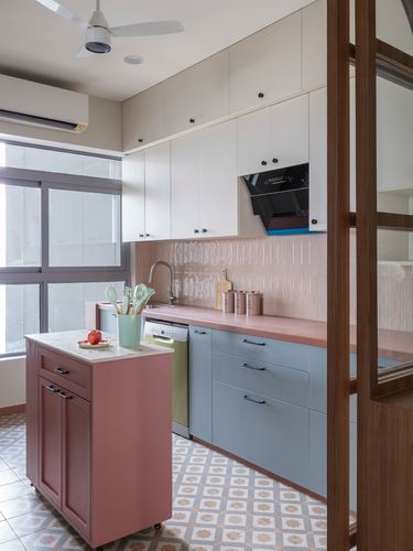 Pastel pink and blue kitchen with ribbed tile backsplash and rolling island, patterned tile floor
