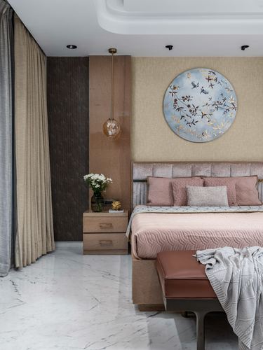 Bedroom with pink tufted headboard, round floral wall art, marble floor, and hanging pendant light