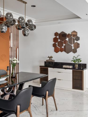 Dining room with marble table, black leather chairs, sideboard and hexagonal mirror wall art
