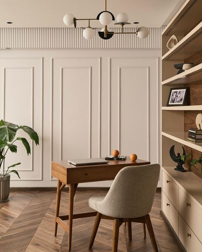 Study nook with wooden desk, cane chair, chevron floor and open wood shelving unit