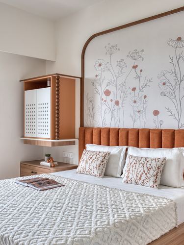 Bedroom with arched wood-framed floral mural wall and terracotta channel-tufted headboard