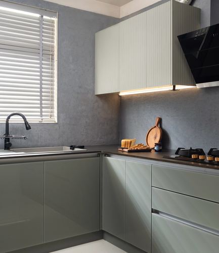 L-shaped kitchen with sage cabinetry, dark countertop, chimney hood and window blinds