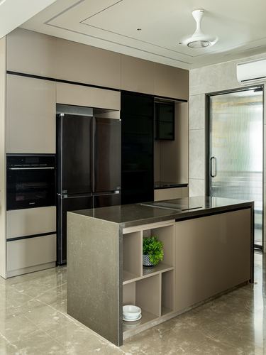 Contemporary taupe kitchen with island, black-panel fridge and stone floor in Surat home
