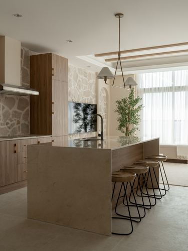 Kitchen island with marble waterfall countertop, wood cabinetry and stacked-stone wall behind