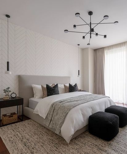 Grey and black minimalist bedroom with chevron wall paneling and sputnik chandelier