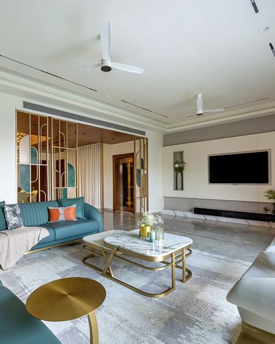 Living room with teal sofa, marble coffee table, brass accents, and decorative screen partition