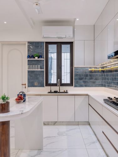 White glossy modular kitchen with blue tile backsplash and marble-look countertop and floor