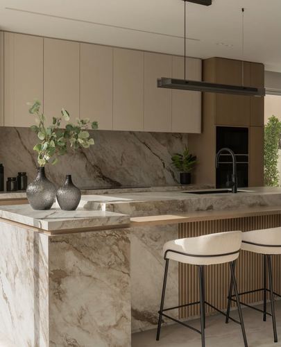 Contemporary kitchen with veined stone waterfall island, beige cabinetry, fluted wood panel and black fixtures