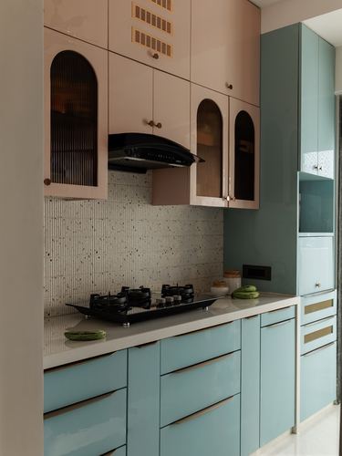 Pastel pink and teal modular kitchen with arched glass cabinets and terrazzo tile backsplash