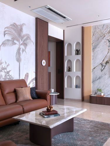 Living room with arched wall niches, marble coffee table, and tan leather sofa against palm-print mural